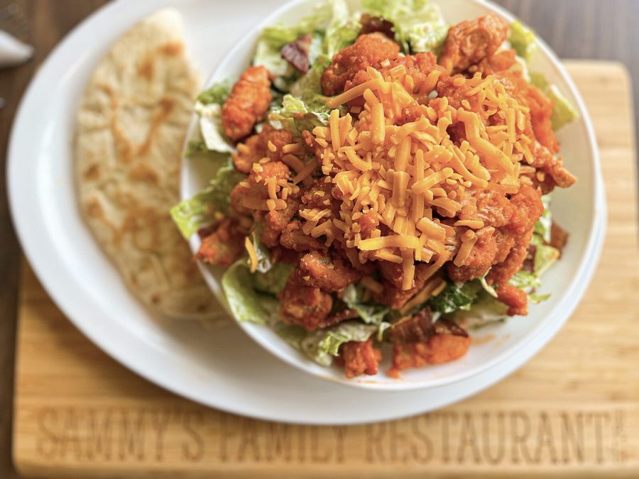 Buffalo chicken Caesar salad topped with cheddar, served with grilled pita